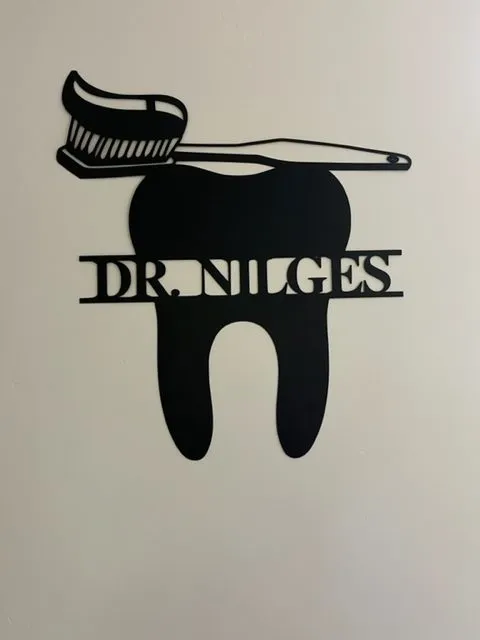 Dr. Brian E. Nilges Logo with teeth and toothbrush at the top