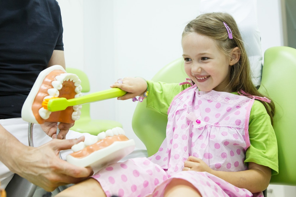 kid.smiling dental.chair